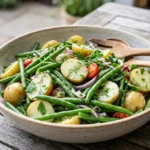 Herby potato green bean salad with mustard dressing, parsley, dill, and tender potatoes.