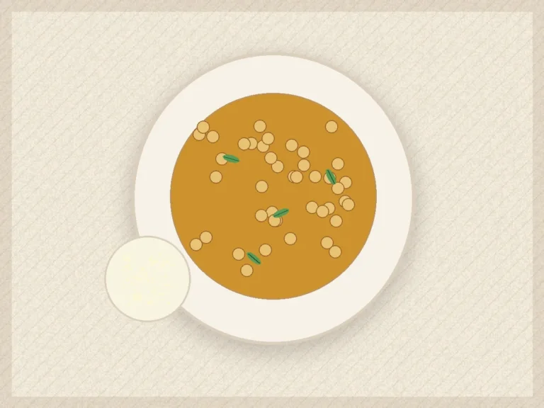 Chickpea spinach curry in coconut tomato sauce served with rice and lemon.