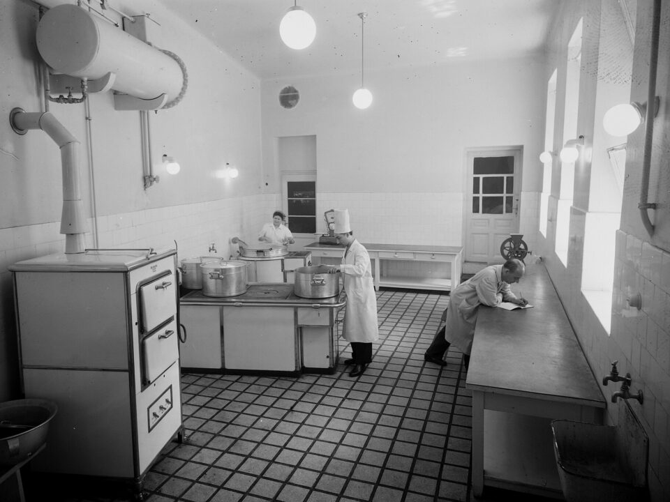 Soup simmering in a wide pot on the stove in warm evening light.