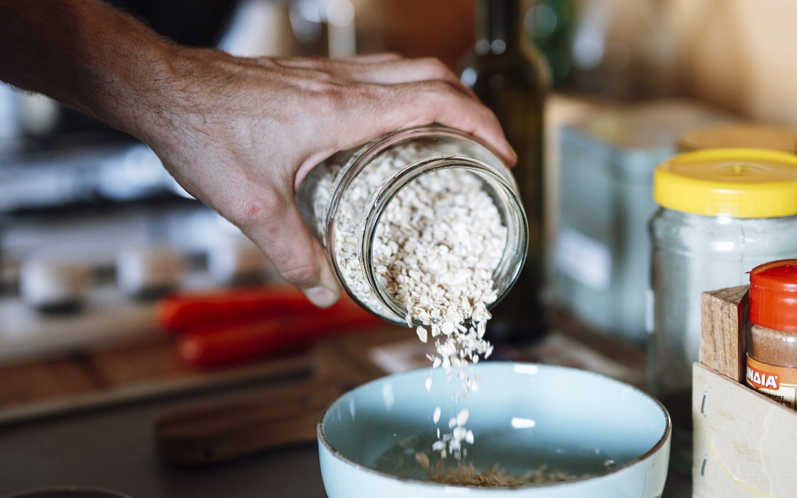 Prepared ingredients, mushrooms, and a notebook arranged on a home kitchen counter.