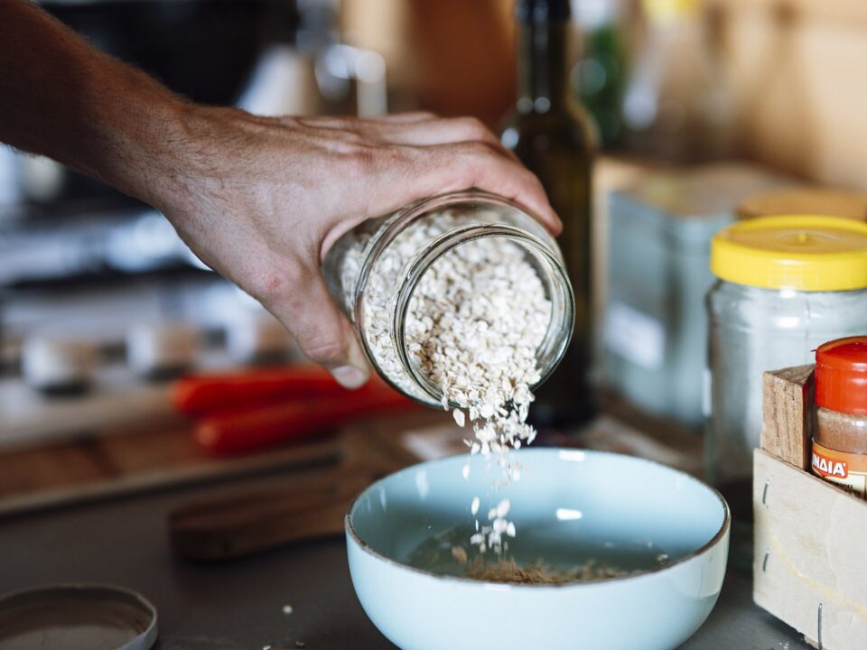 Prepared ingredients, mushrooms, and a notebook arranged on a home kitchen counter.