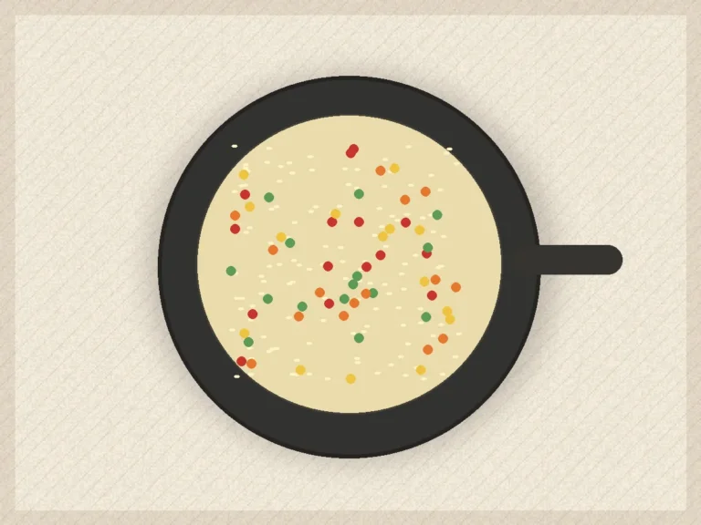 Vegetable rice skillet with peas, carrots, red pepper, herbs, and lemon on top.