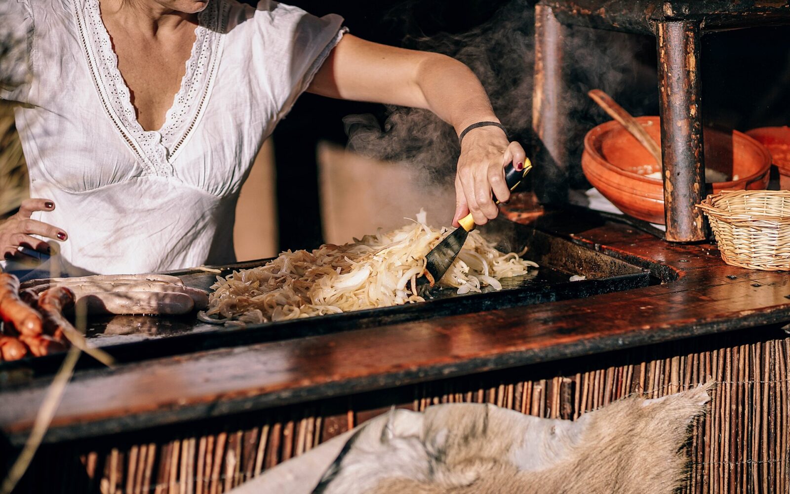 Yellow onion slices softening in olive oil in a skillet.